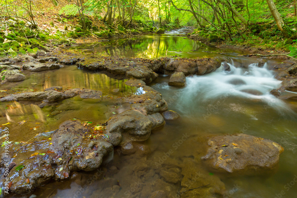 Obraz premium Pristine river and waterfalls in the mountains, in autumn