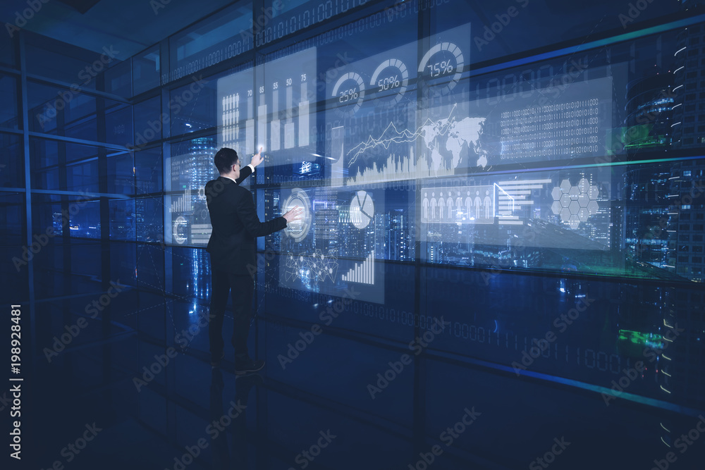 Young businessman working with vitual screen Young businessman working with vitual screen