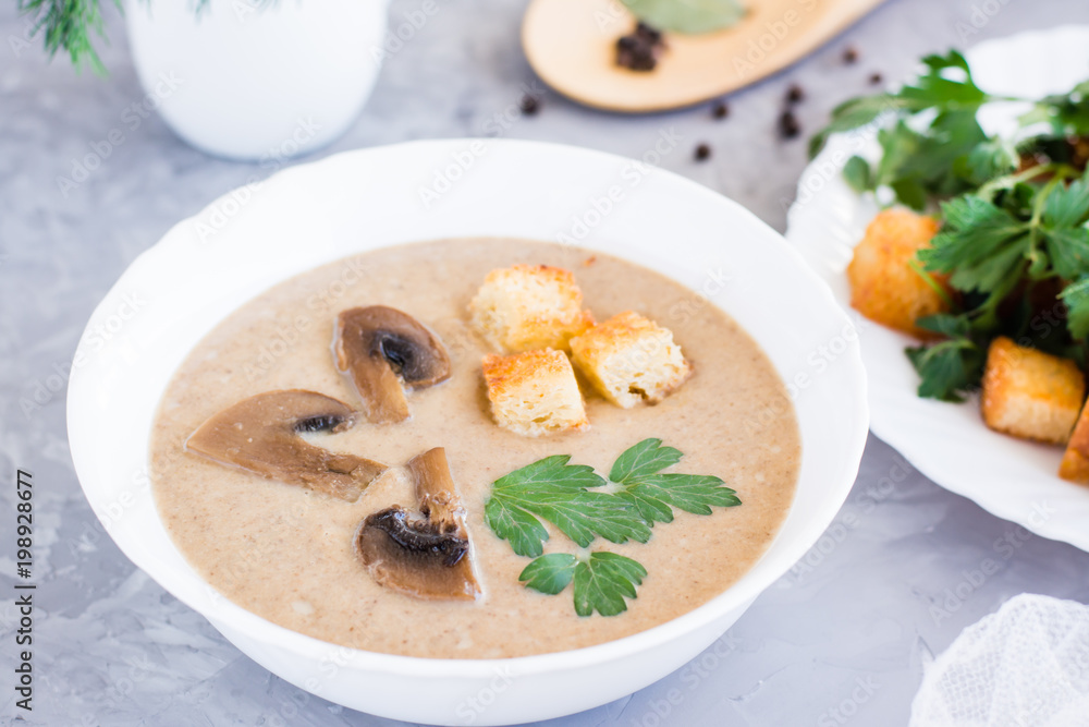 Homemade mushroom cream soup with champignons and breadcrumb
