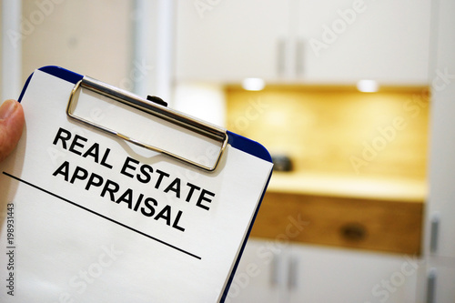 Man holding clipboard with Real estate appraisal. photo