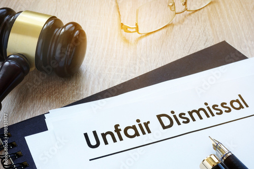 Documents unfair dismissal and gavel in a court.