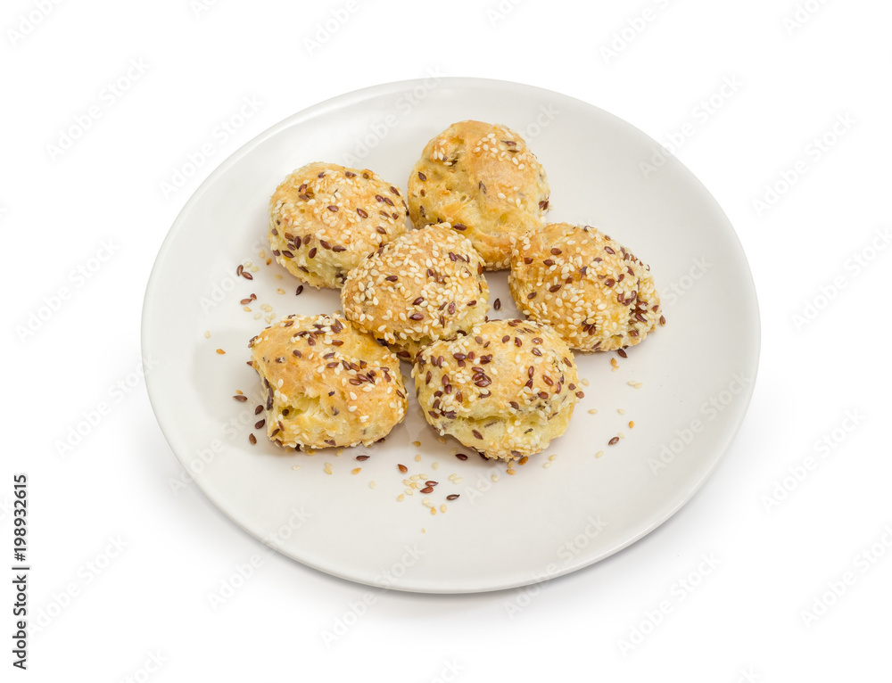 Savory profiterole sprinkled with flax and sesame seeds on dish Savory profiterole sprinkled with flax and sesame seeds on dish