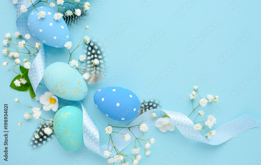 Easter eggs on a blue background with empty space. Easter card. Top view