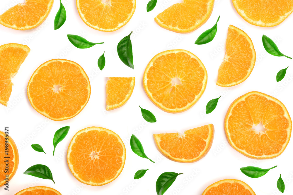 Slices of orange or tangerine decorated with green leaves isolated on white background, top view. Fruit composition Slices of orange or tangerine decorated with green leaves isolated on white background, top view. Fruit composition