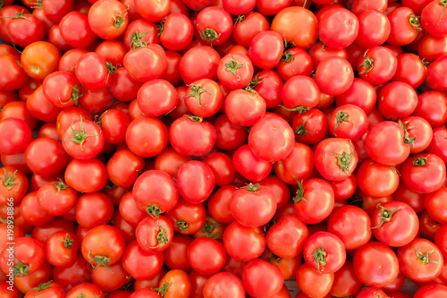 Clean eating concept. Bunch of ripe juicy freshly picked organic cherry tomatoes in pile at local produce farmers market. Healthy diet for spring summer detox. Vegan raw food. Close up  background.