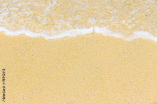 Ocean wave on sandy beach. Background.