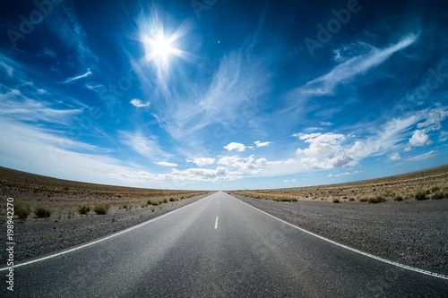 Obraz na plátně Asphalt road in the desert and sky with clouds