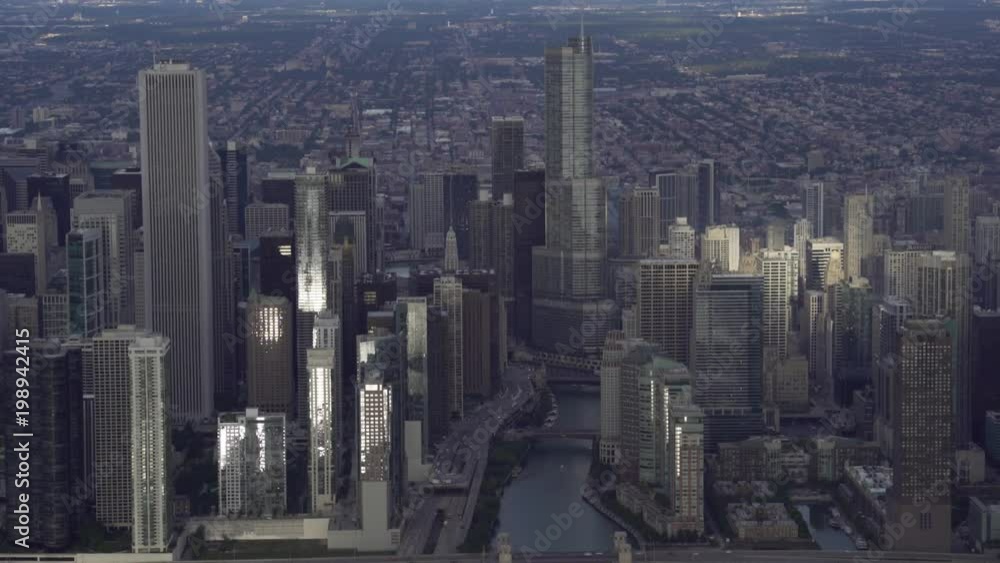 Chicago aerial view of Trump International Hotel and Tower center focused moving along the waterfront looking down the Chicago River at sunrise Chicago aerial view of Trump International Hotel and Tower center focused moving along the waterfront looking down the Chicago River at sunrise