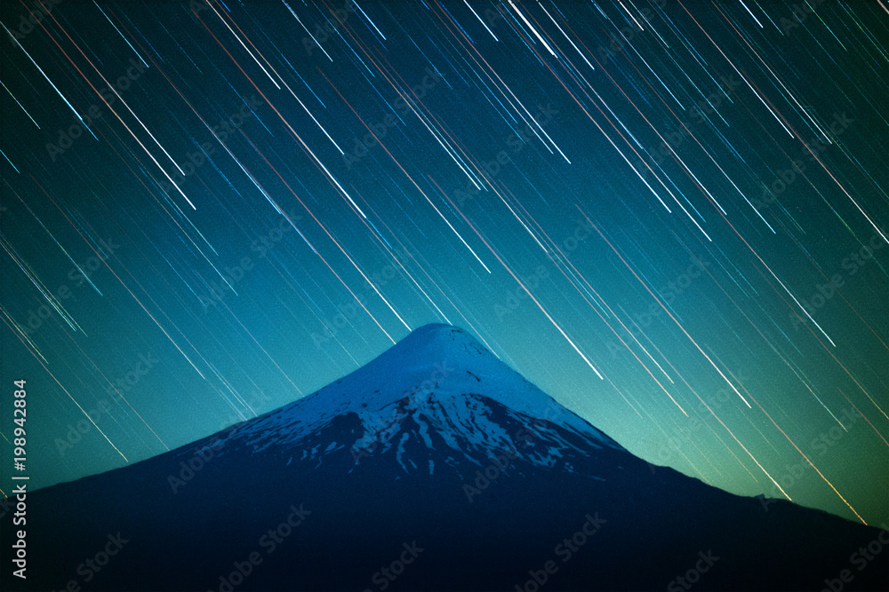 Foto Stock Volcano of Osorno and night sky with star trails. Patagonia,  Chile | Adobe Stock