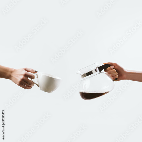 cropped view of hands with coffee cup and glass pot, isolated on white
