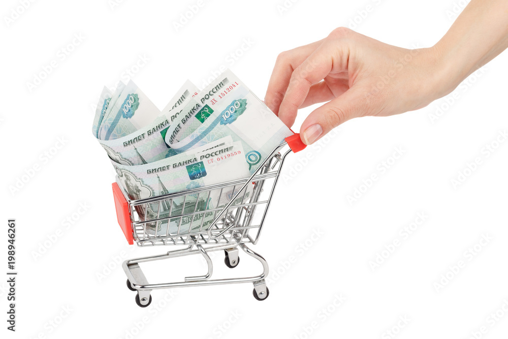 Hand with Russian rubles in the shopping cart, isolated on white