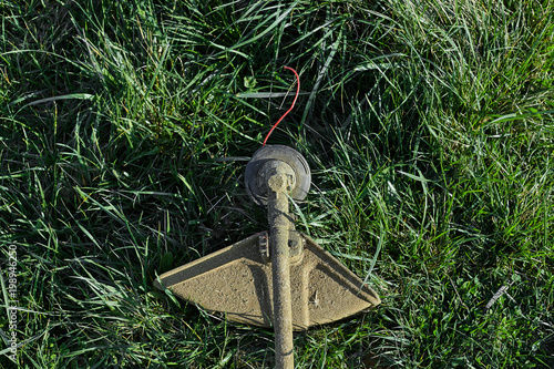 Closeup view of a grass trimmer in garden. photo