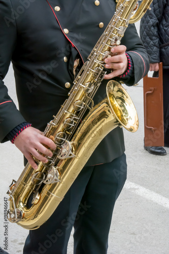 Vertical View of Close Up of Musician Playing Saxophone in Black Uniform. Taranto, South of Italy