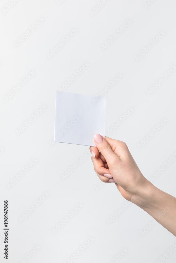 cropped shot of woman holding blank note in hand isolated n white cropped shot of woman holding blank note in hand isolated n white