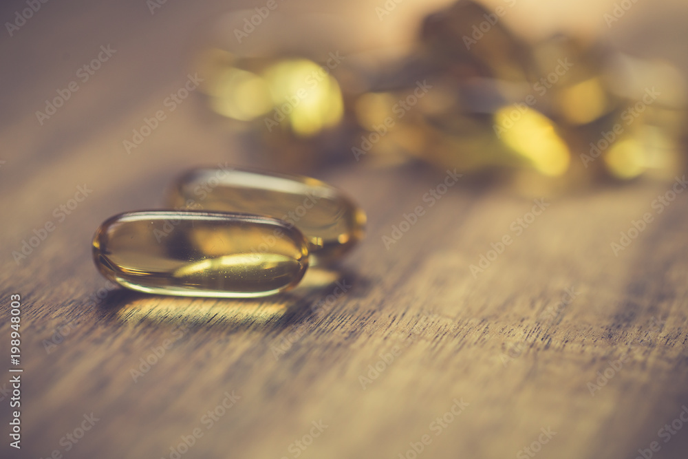 Fish oil capsules with omega 3 and vitamin D. Healthy diet concept Fish oil capsules with omega 3 and vitamin D. Healthy diet concept