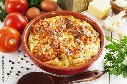 Cauliflower baked with tomato, cheese and eggs