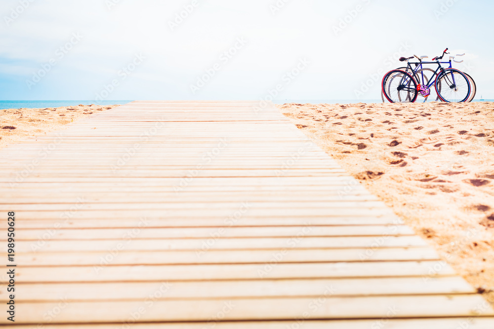 Fototapeta premium The end of the wooden road leading to the sea. Bicycle park.