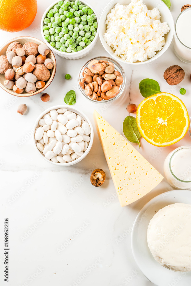 Healthy food concept. Set of food rich in calcium - dairy and vegan Ca products, white marble background copy space top view