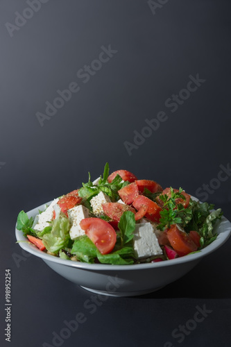 Large portion of raw salad and cheese