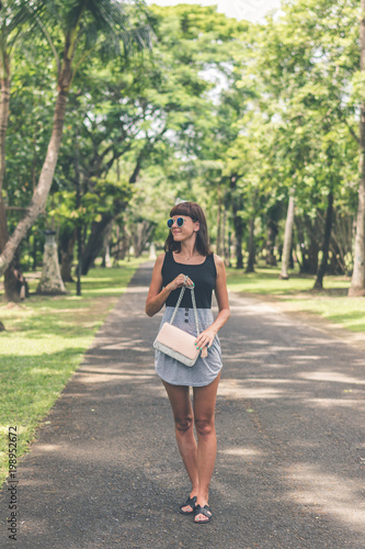 Fashionable woman with luxury snakeskin python handbag outside. Snakeskin fashion concept. © belart84