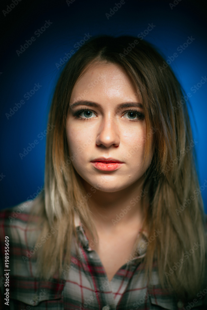 portrait smiling girl on blue background in studio portrait smiling girl on blue background in studio