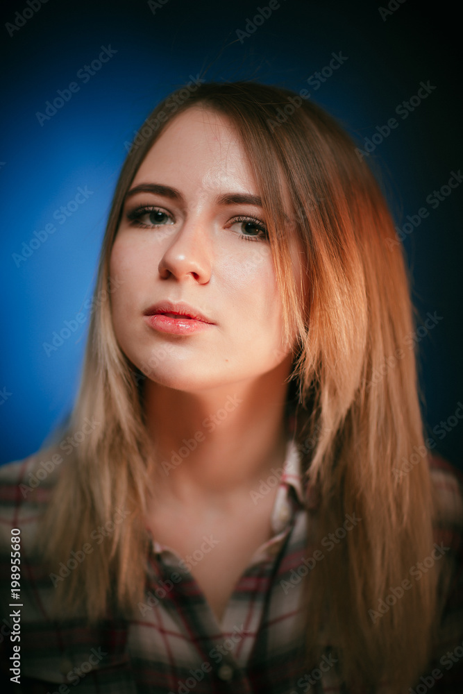 portrait smiling girl on blue background in studio portrait smiling girl on blue background in studio