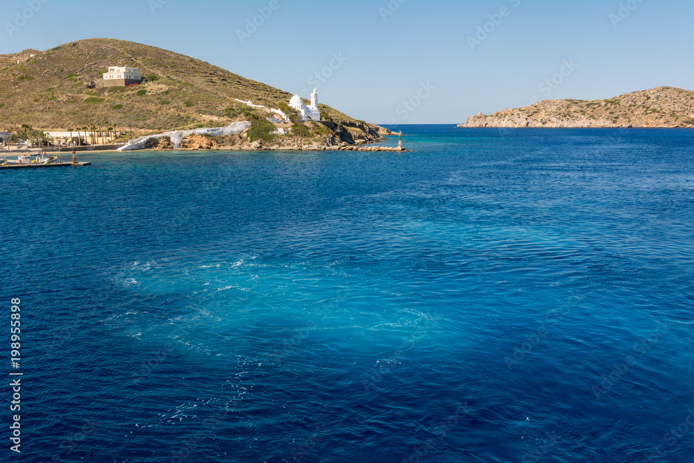 Blue sea water of Aegean Sea surrounded by beautiful coast of Island of Ios. Greece.