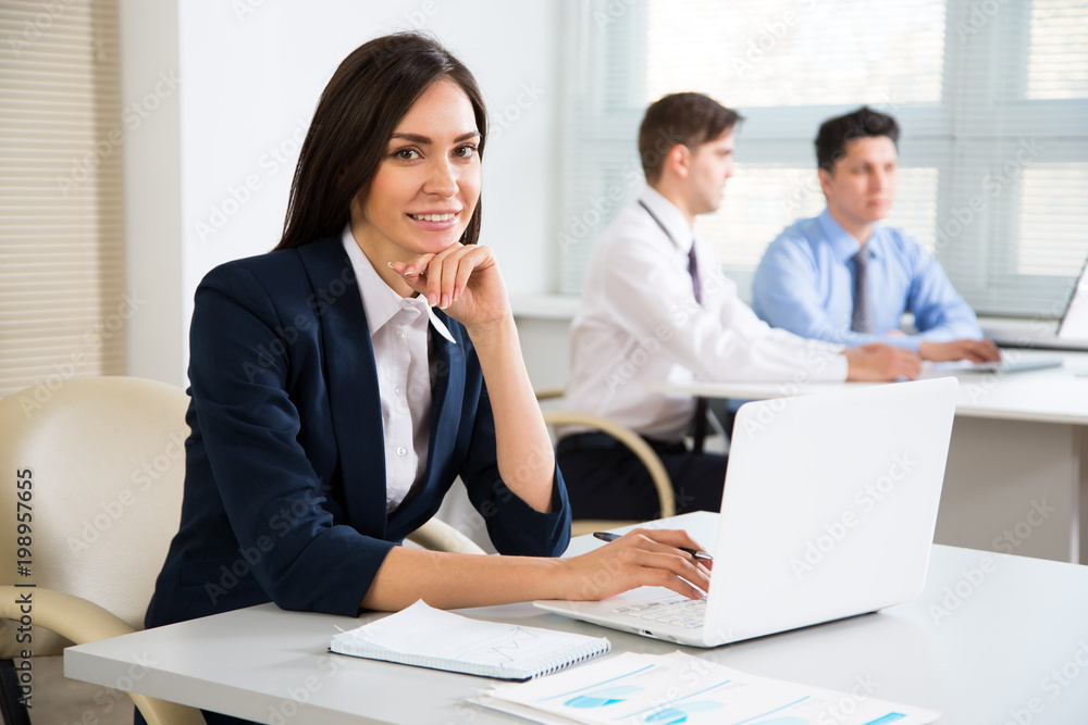 Young business woman smiling looking at camera Young business woman smiling looking at camera