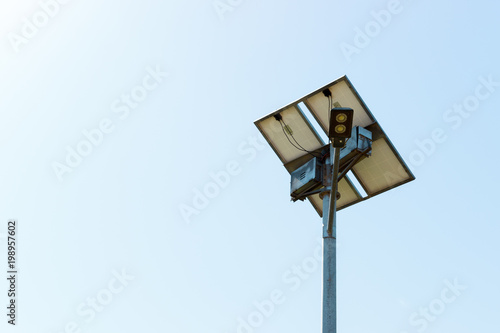 Street lamp with solar cell panel on blue sky background