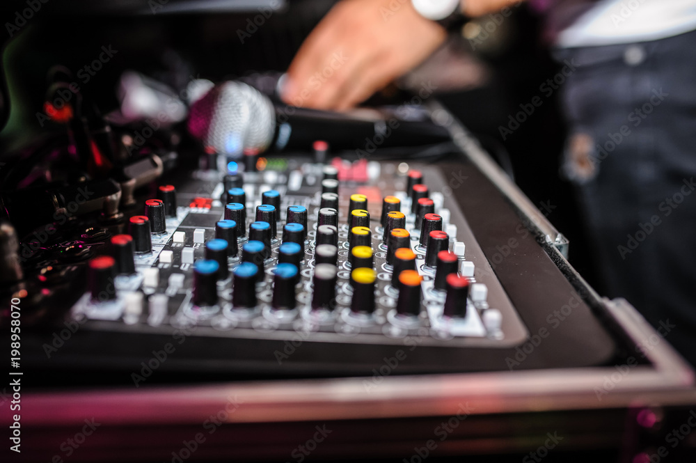 Close up of dj control panel playing party music on modern player in disco club Close up of dj control panel playing party music on modern player in disco club