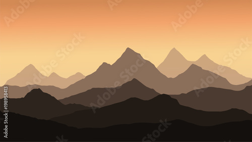 panoramic view of the mountain landscape with fog in the valley below with the alpenglow orange sky and rising sun
