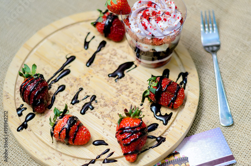 Dessert trifle with blueberry cream and strawberries. photo