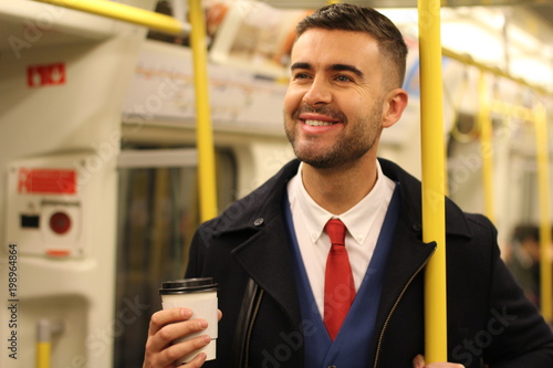 Cheerful businessman using public transportation