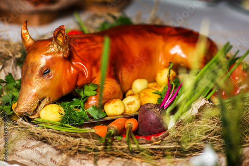 Baked small pig with vegetables. The concept of food and Ukrainian cuisine