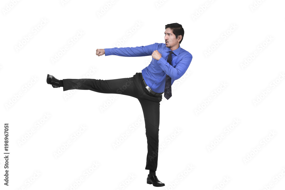 Attractive asian businessman kicking something