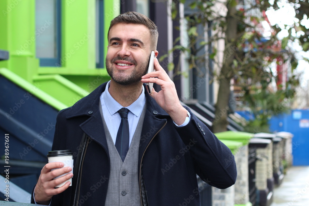 Businessman calling by phone from house door Businessman calling by phone from house door