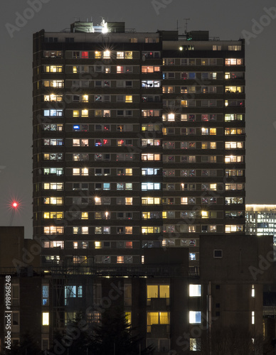 Towerblock at night, showing the variety of lives and lights that exist in a single apartment block in London