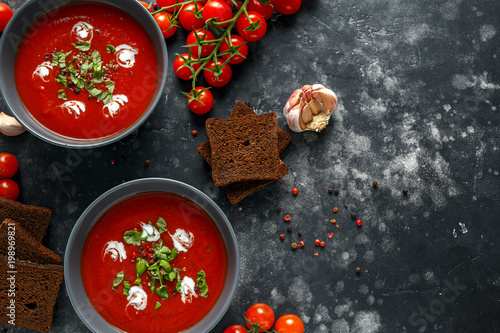 Tomato and fresh basil soup with garlic, cracked papper corns, served with cream and sourdough bread
