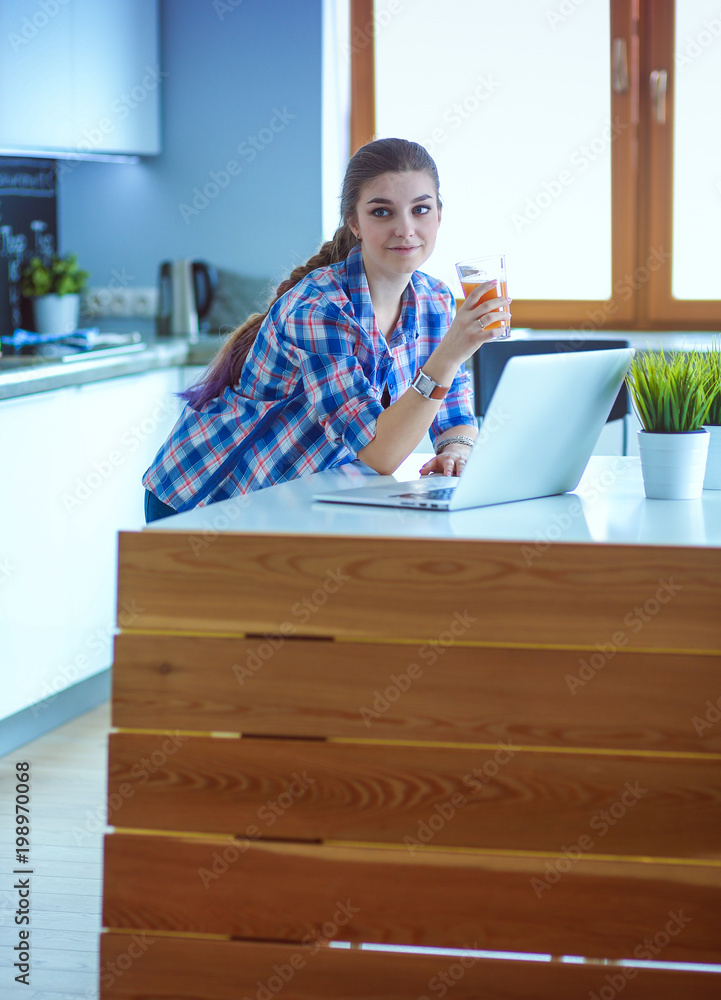 Beautiful young smiling female doctor sitting at the desk and writing. Beautiful young smiling female doctor sitting at the desk and writing.