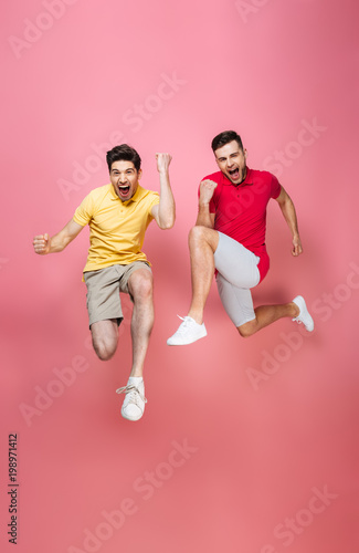 Full length portrait of a cheerful gay couple celebrating
