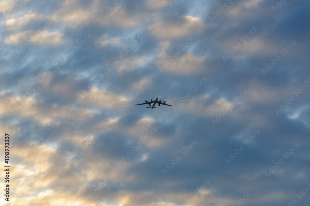 Silhouette of the plane in the clouds at sunset Silhouette of the plane in the clouds at sunset