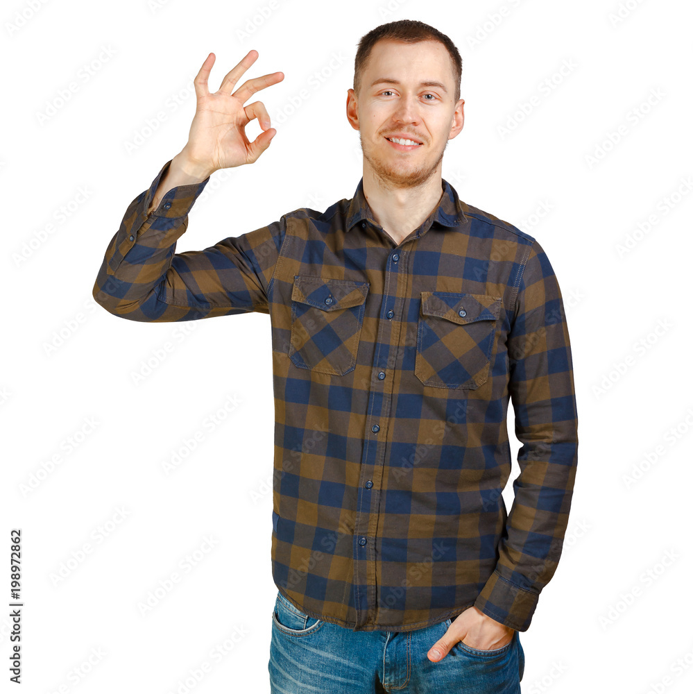 A nice young man wearing green checkered shirt shows Ok symbol. Isolated on white background. A nice young man wearing green checkered shirt shows Ok symbol. Isolated on white background.