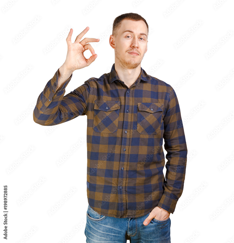 A nice young man wearing green checkered shirt shows Ok symbol. Isolated on white background. A nice young man wearing green checkered shirt shows Ok symbol. Isolated on white background.