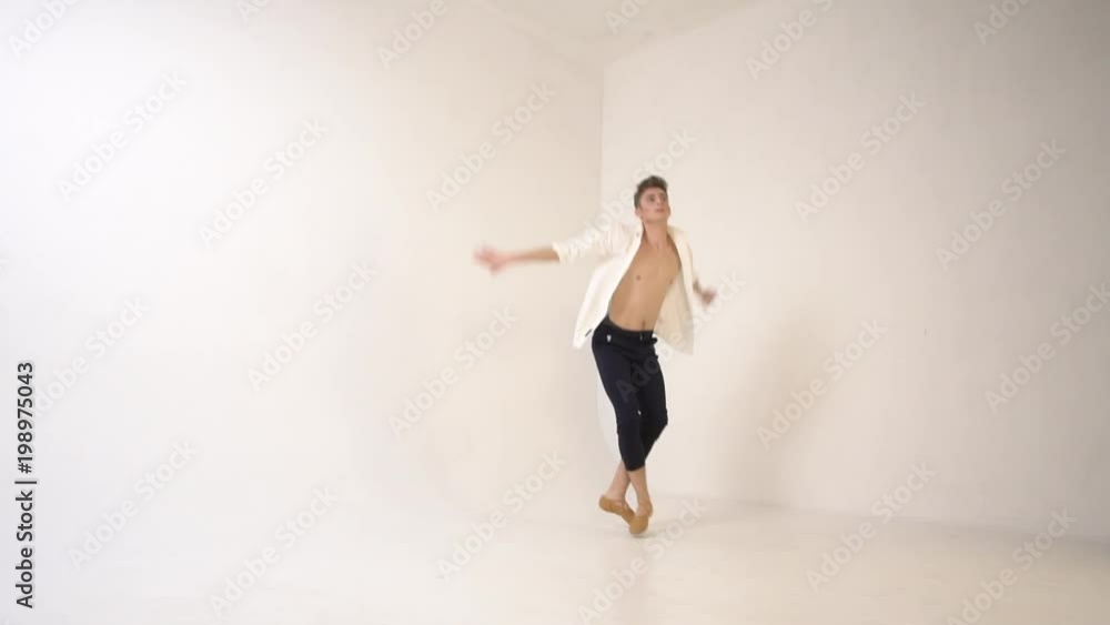 A man balerun dances on a white background and jumps high A man balerun dances on a white background and jumps high