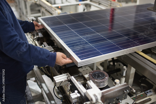 production of solar panels, man working in factory.