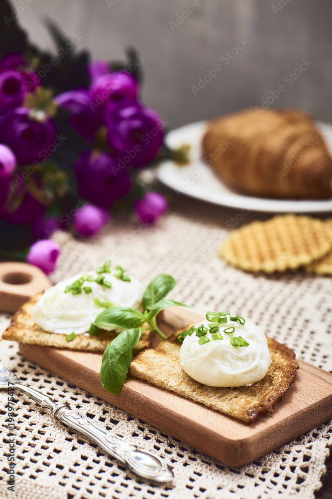 Tasty poached egg on toast over rustic background Tasty poached egg on toast over rustic background