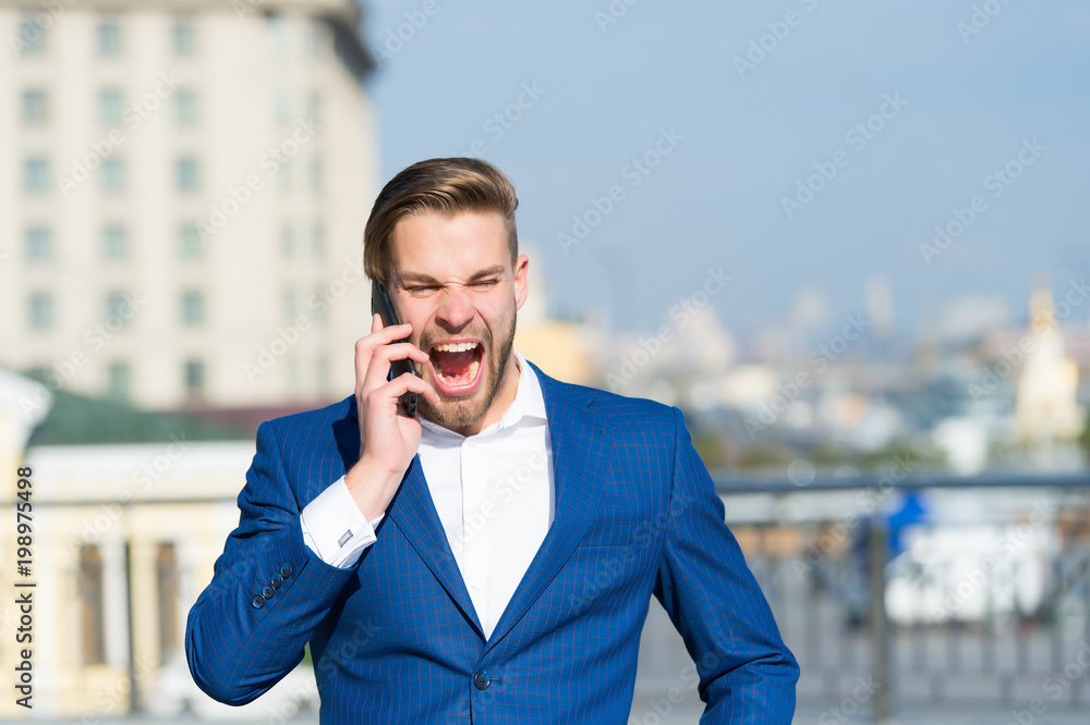 Happy manager talk on smartphone. Man with mobile phone on sunny terrace. Businessman in blue suit outdoor. Business communication, new technology and sms. Modern life and business lifestyle Happy manager talk on smartphone. Man with mobile phone on sunny terrace. Businessman in blue suit outdoor. Business communication, new technology and sms. Modern life and business lifestyle