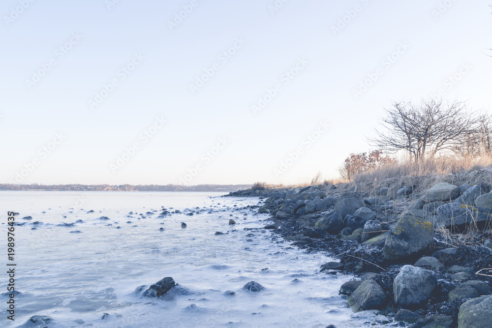 Rocks in the frozen sea on a coastline Rocks in the frozen sea on a coastline