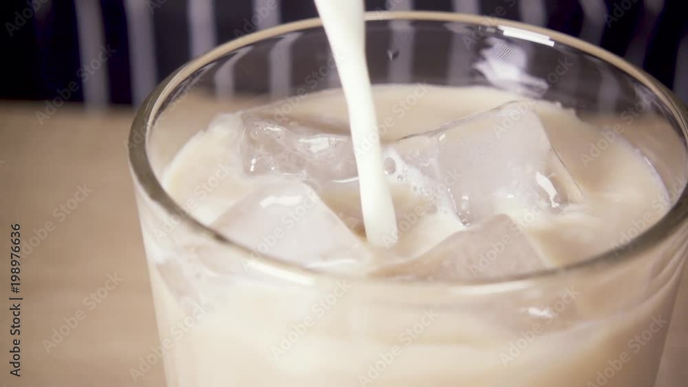 Slow Motion Close-up Milk is poured into the ice Slow Motion Close-up Milk is poured into the ice