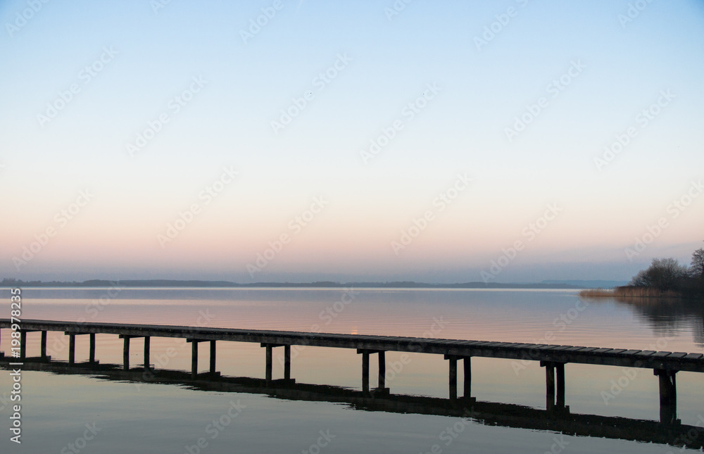 Panorama, footbridge, and quiet scene on the lake in the north, Germany Panorama, footbridge, and quiet scene on the lake in the north, Germany